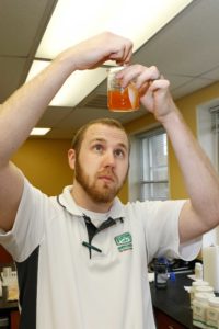 Food Scientist Adam Shaffer mixes of solution of seasonings for testing.