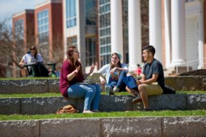 Christina (Sunshine) DeJoseph, center, chats with fellow McDaniel students Olivia Belitsos and Alfonso Navarro while on campus.
