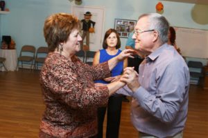June Renner gives instructions to Marty Sitterding and Tom Stansfield during a salsa dance class. 